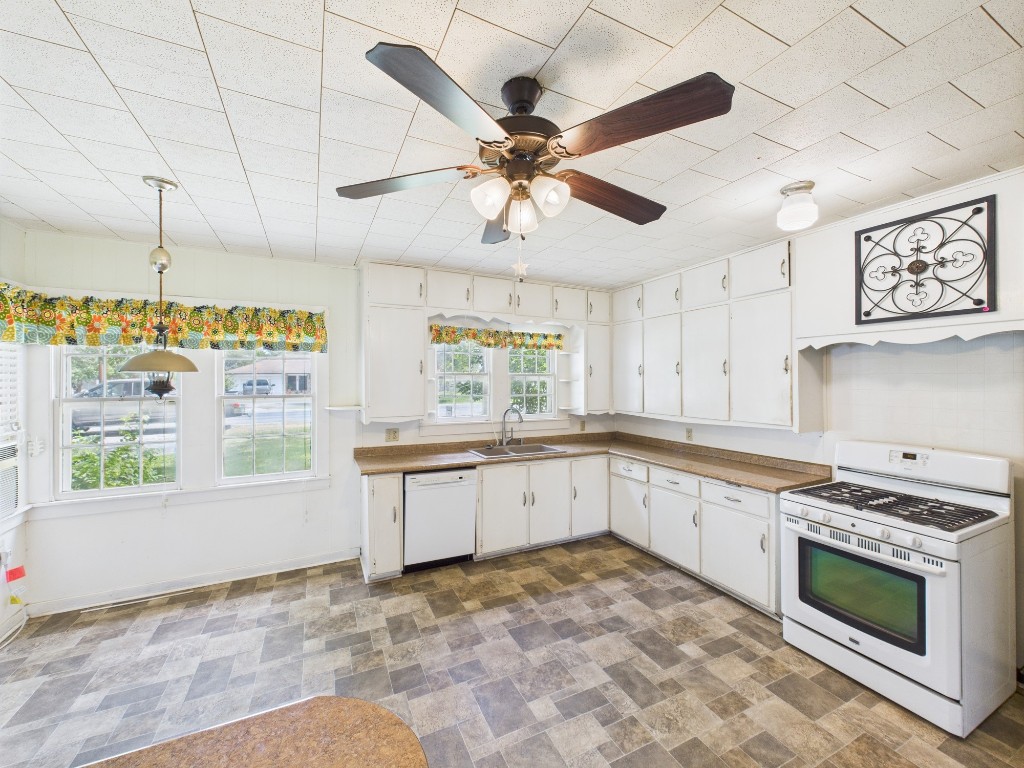 305 West Converse Street Weimar, TX 78962 - Photo 26 of 30 a kitchen with stainless steel appliances granite countertop a stove cabinets and window