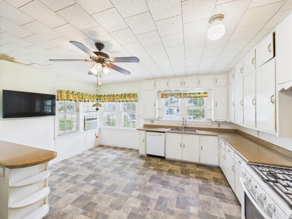 305 West Converse Street Weimar, TX 78962 - Photo 27 of 30 a large white kitchen with a stove a sink dishwasher and a refrigerator