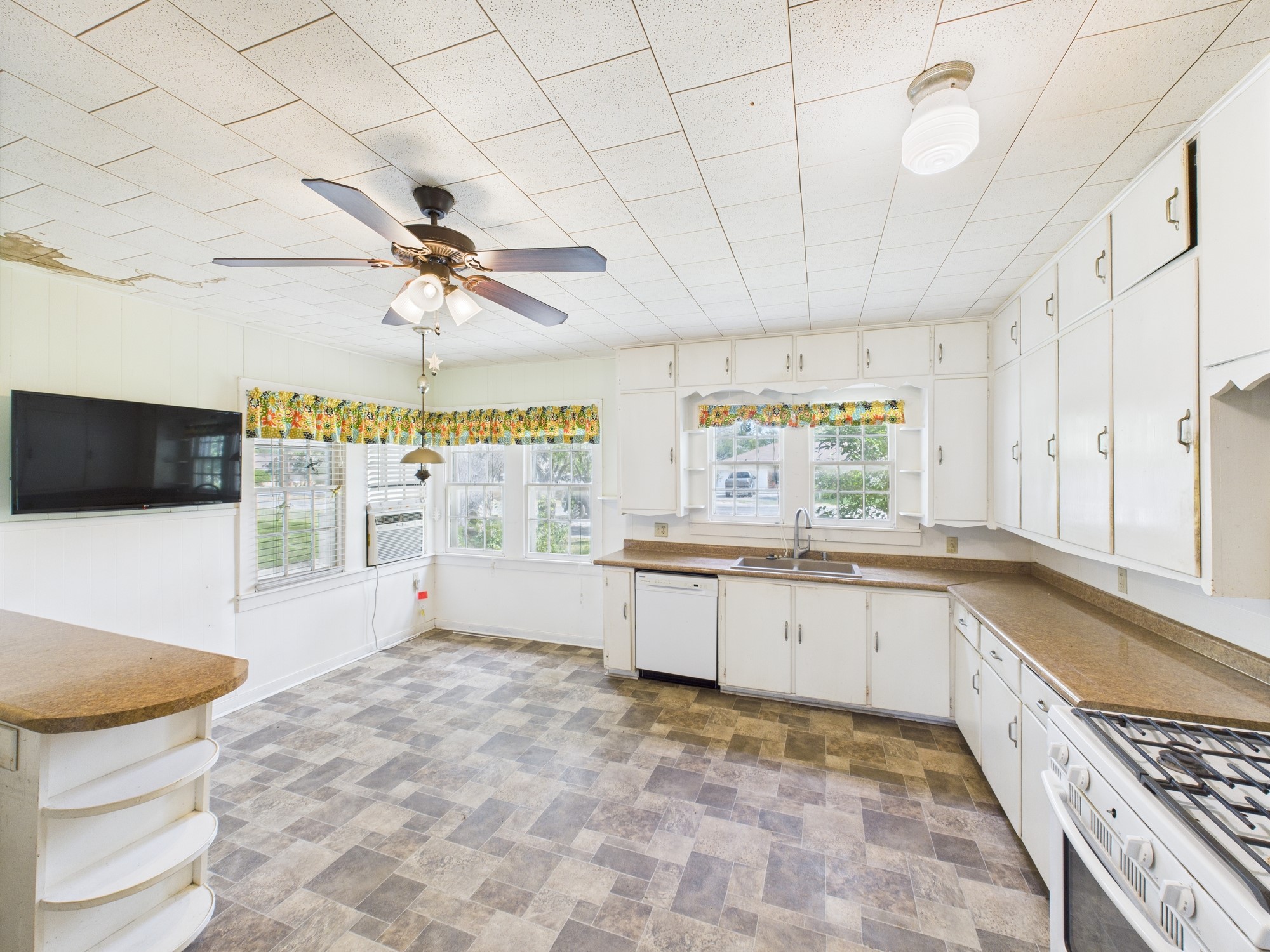 305 West Converse Street Weimar, TX 78962 - Photo 27 of 30 a large white kitchen with a stove a sink dishwasher and a refrigerator