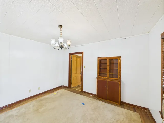 a view of a livingroom with a chandelier fan