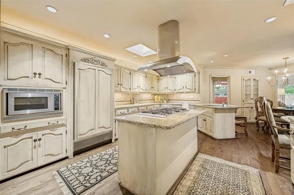 a kitchen with granite countertop a sink stove and refrigerator