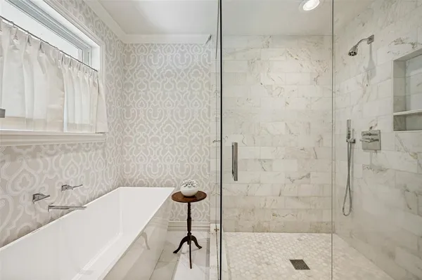 a bathroom with a bathtub and shower