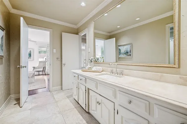 a spacious bathroom with a sink and a mirror