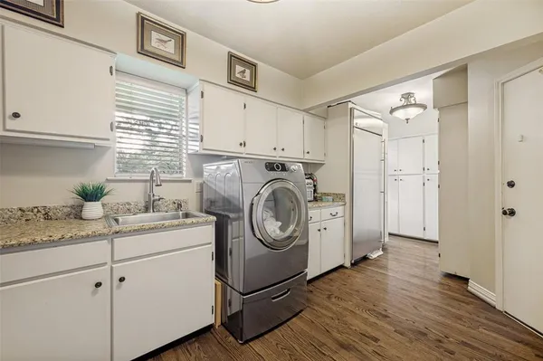 a utility room with sink dryer and washer