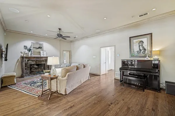 a living room with furniture and a wooden floor