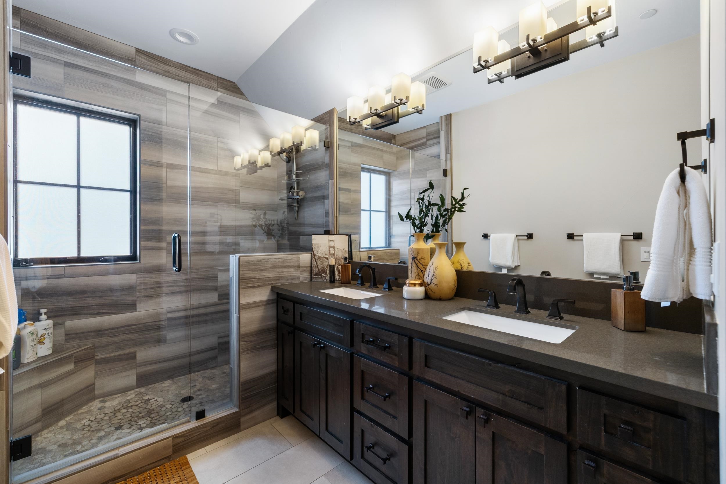 10601 Carson Range Road Truckee, CA 96161 - Photo 16 of 28 a bathroom with a double vanity sink a mirror and a shower