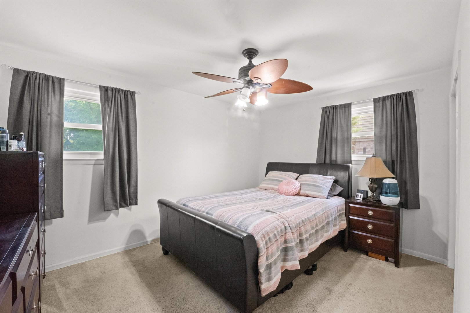 509 Spring Street Roselle, IL 60172 - Photo 11 of 31 a bedroom with a bed and a chandelier