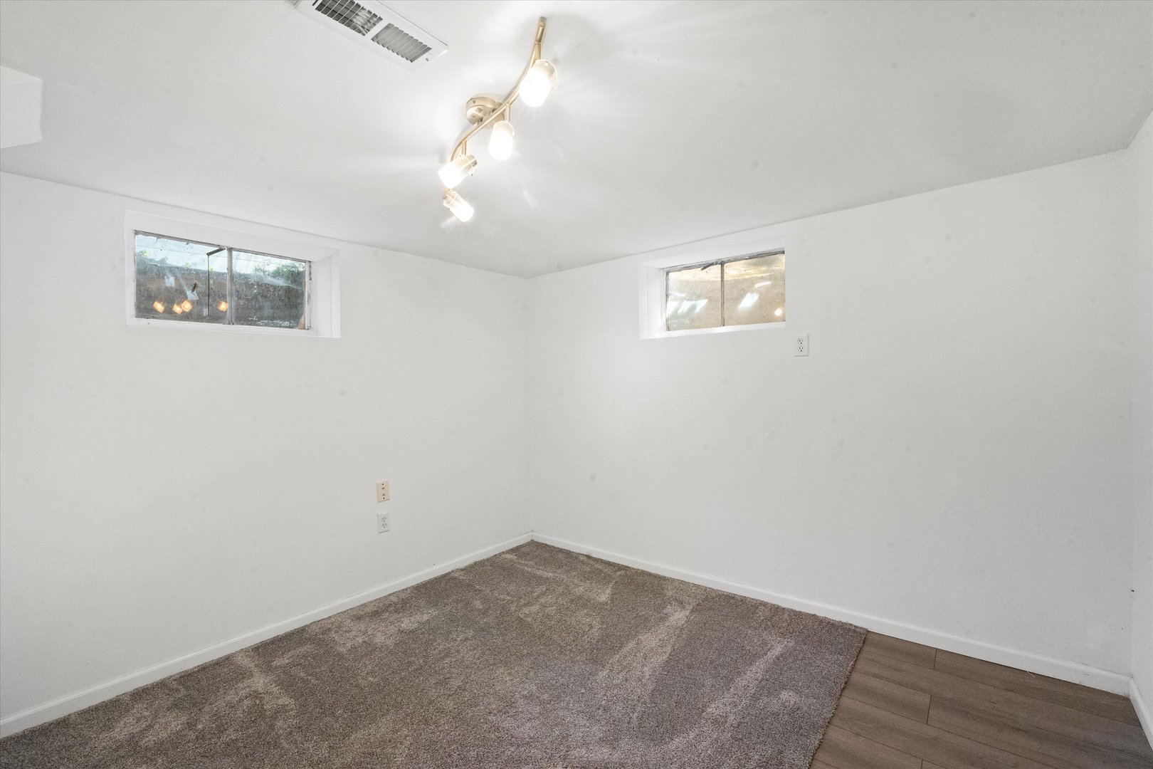 509 Spring Street Roselle, IL 60172 - Photo 17 of 31 an empty room with wooden floor and window