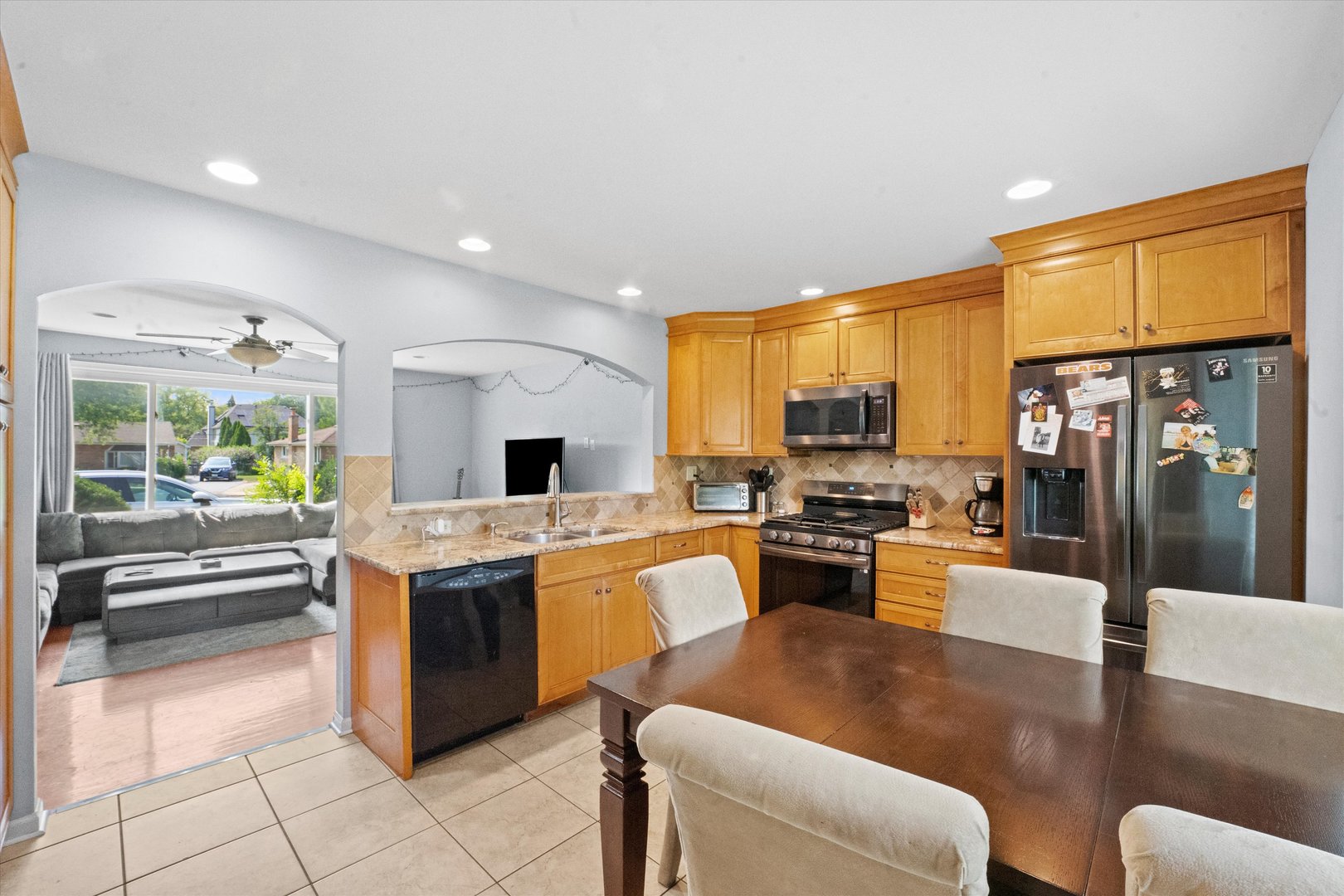 509 Spring Street Roselle, IL 60172 - Photo 7 of 31 a large kitchen with stainless steel appliances kitchen island granite countertop a large kitchen island a stove a sink a dining table and chairs