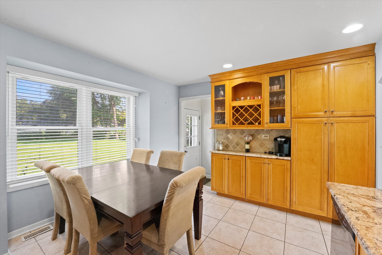 509 Spring Street Roselle, IL 60172 - Photo 9 of 31 a view of a dining room with furniture and window