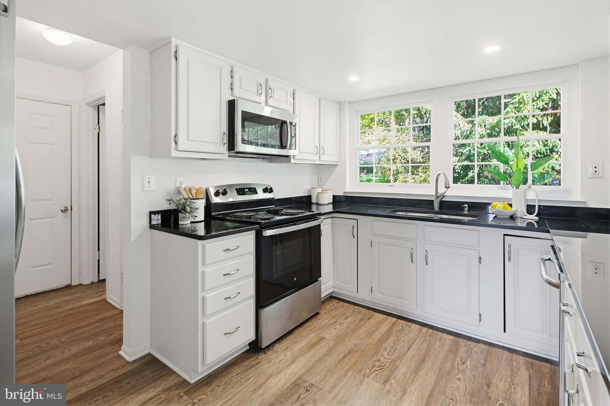 4608 Old Dragon Path Ellicott City, MD 21042 - Photo 11 of 60 a kitchen with stainless steel appliances white cabinets and a sink