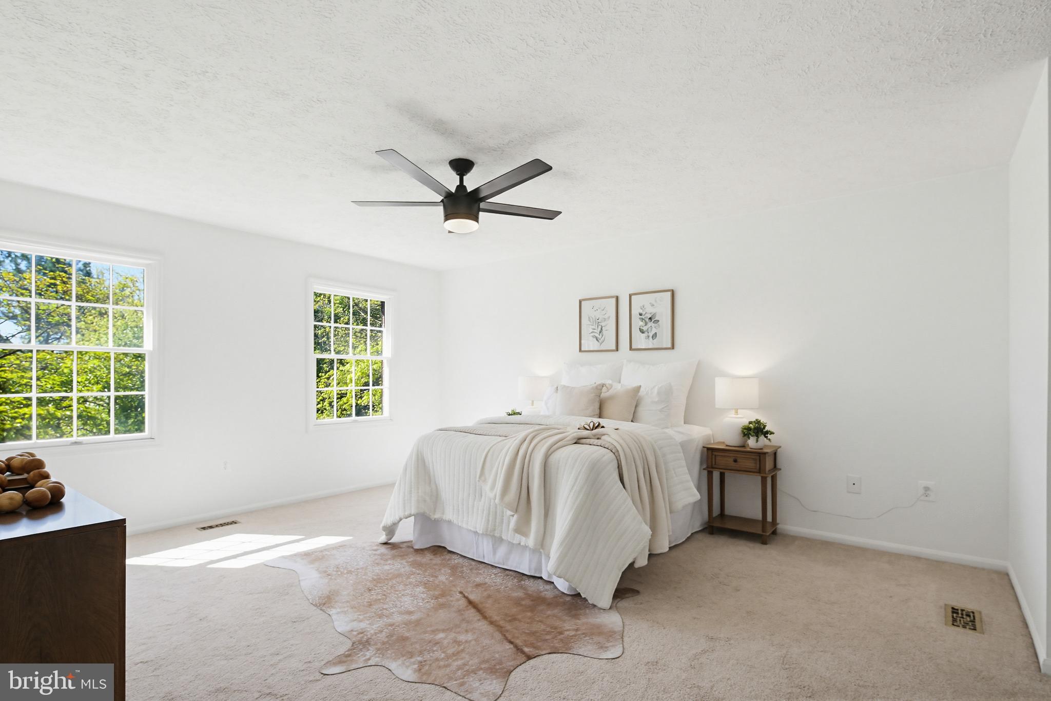 4608 Old Dragon Path Ellicott City, MD 21042 - Photo 25 of 60 a spacious bedroom with a bed a couch and a window