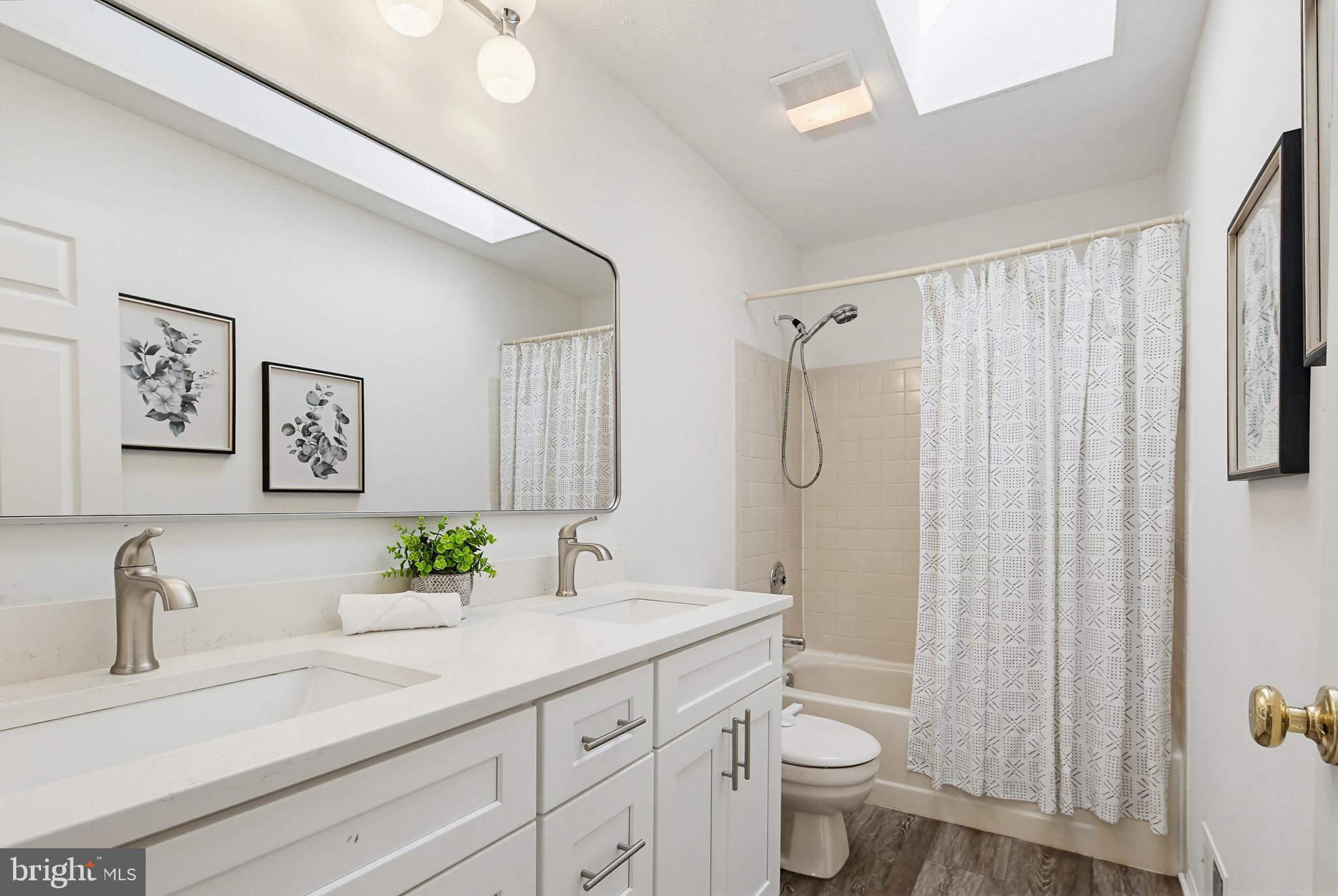 4608 Old Dragon Path Ellicott City, MD 21042 - Photo 35 of 60 a bathroom with a granite countertop sink a toilet and a shower