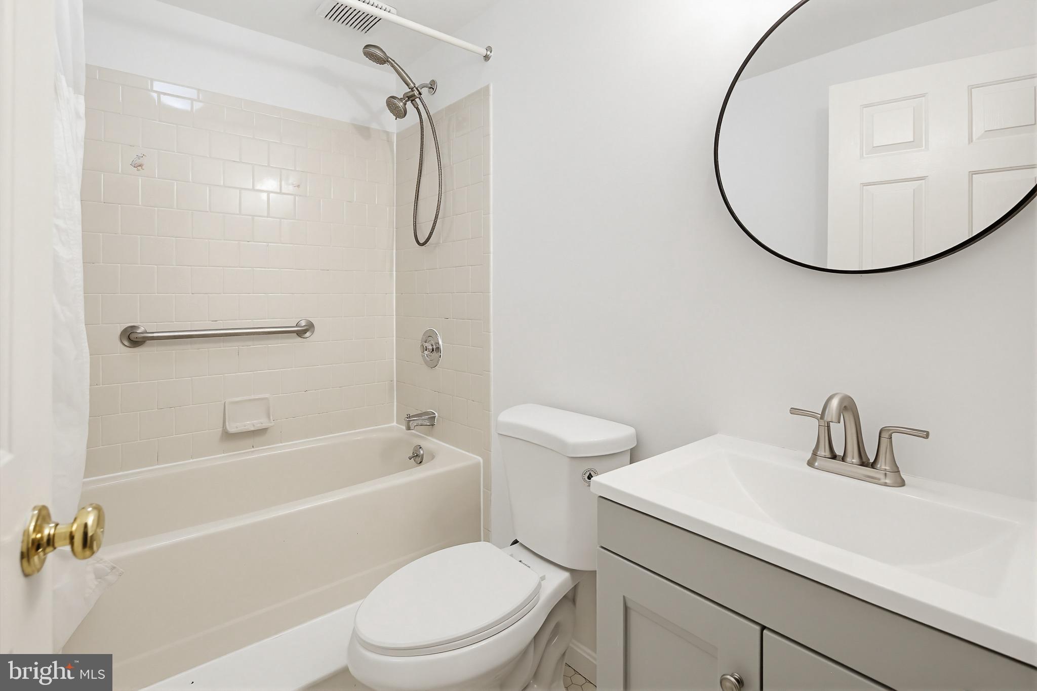 4608 Old Dragon Path Ellicott City, MD 21042 - Photo 49 of 60 a bathroom with a sink a toilet and a mirror