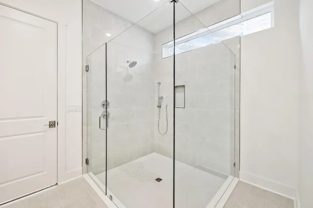 a bathroom that has a glass shower door