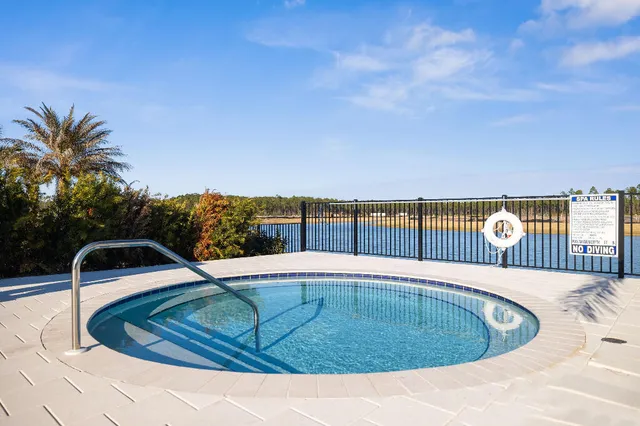 a swimming pool with lawn chairs