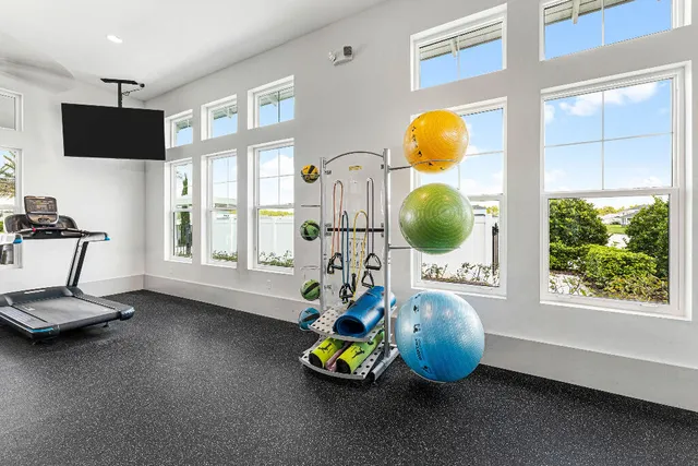 a room with pool table and windows