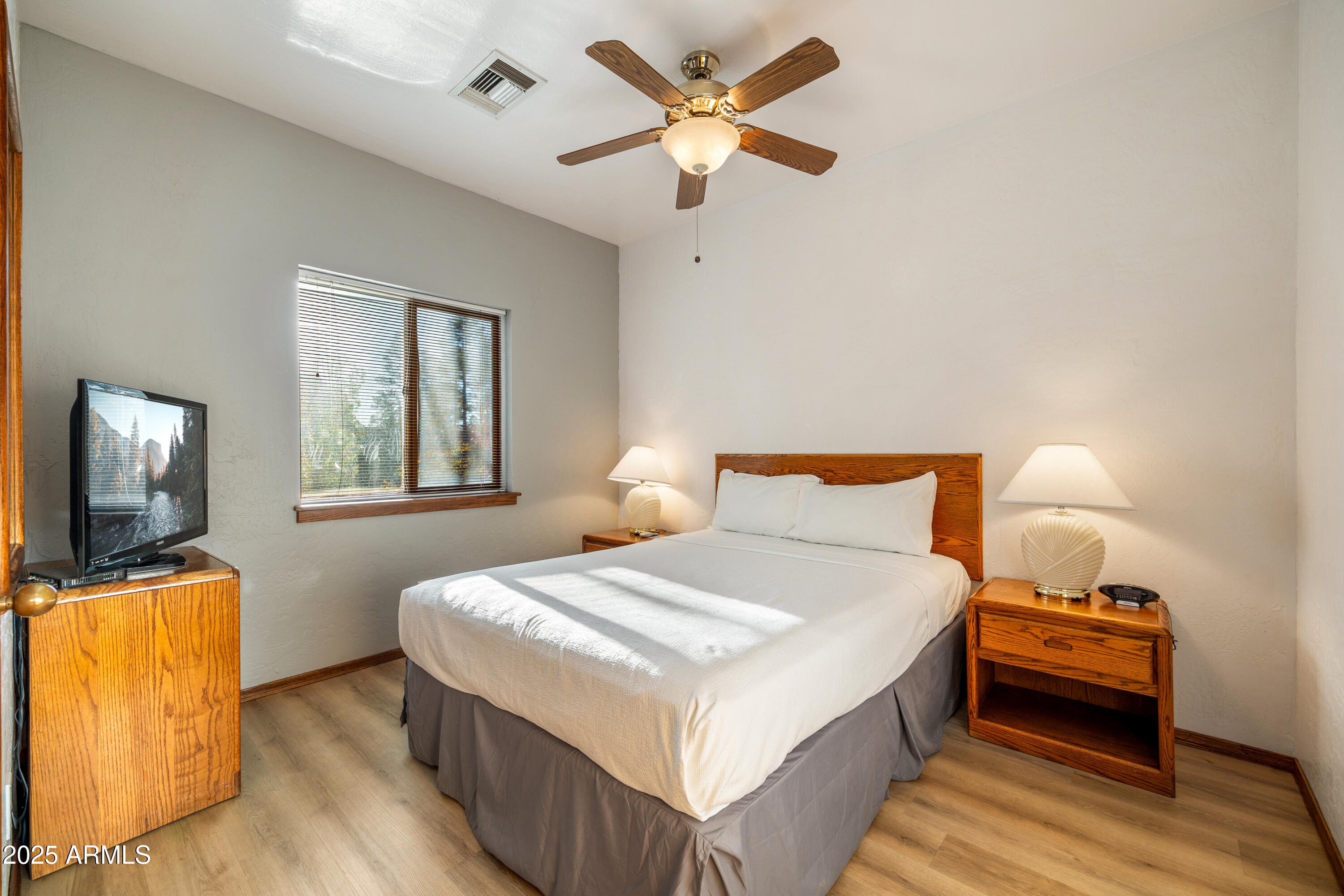 5829 East Buck Springs Road, Unit 255 Pinetop, AZ 85935 - Photo 11 of 21 a bedroom with a bed and a flat screen tv