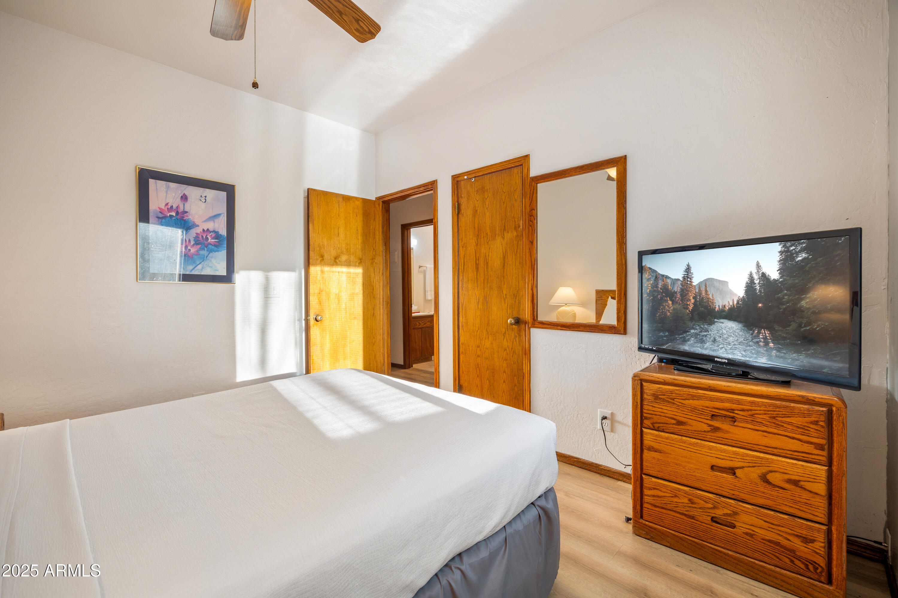 5829 East Buck Springs Road, Unit 255 Pinetop, AZ 85935 - Photo 12 of 21 a bedroom with a bed and a flat screen tv