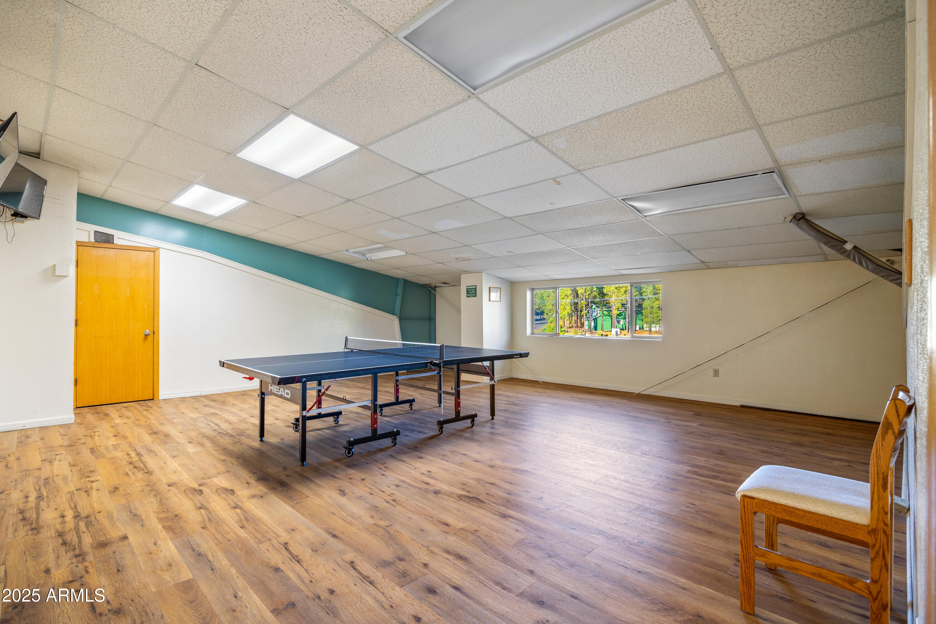 5829 East Buck Springs Road, Unit 255 Pinetop, AZ 85935 - Photo 18 of 21 a view of game room with window and wooden floor
