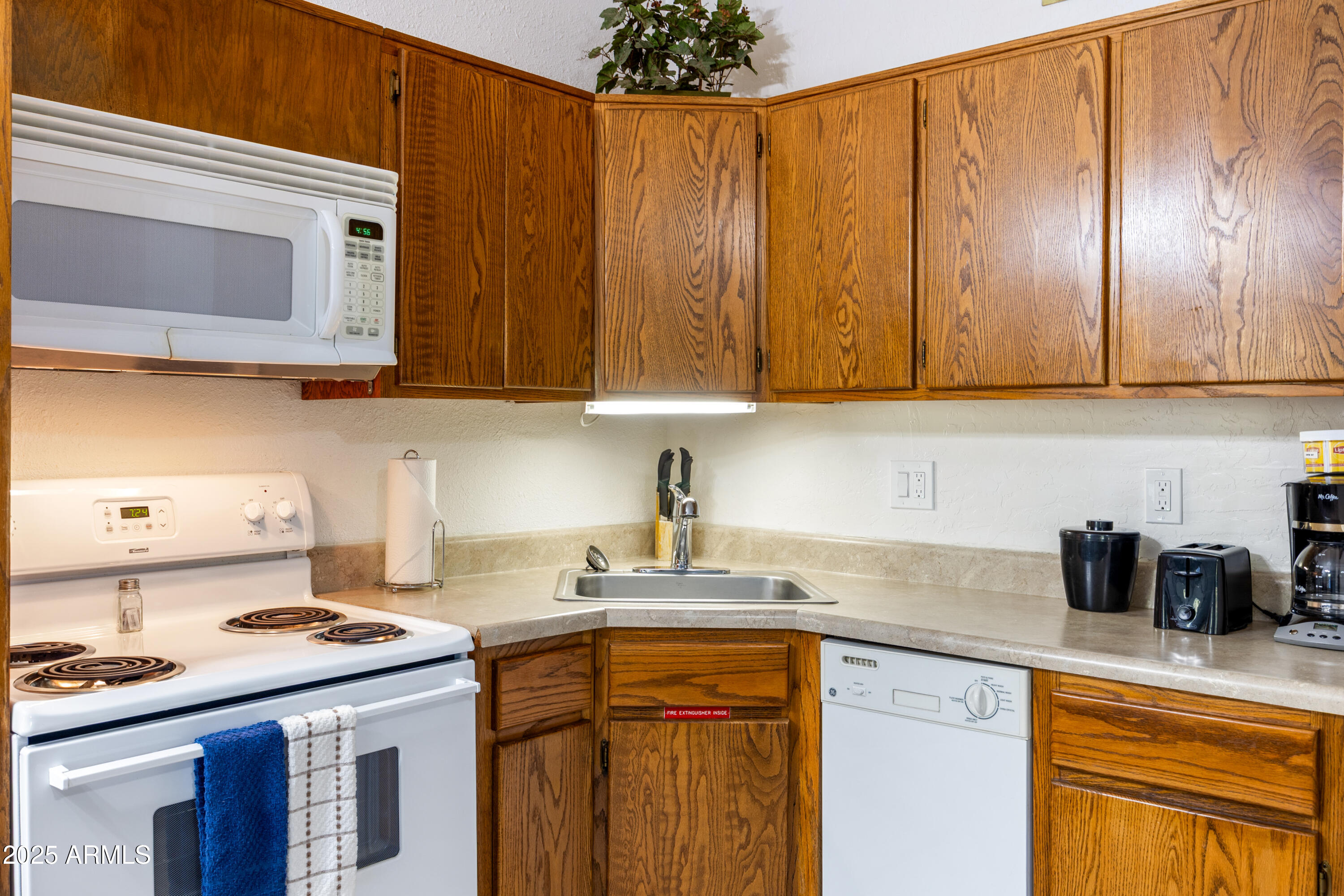 5829 East Buck Springs Road, Unit 255 Pinetop, AZ 85935 - Photo 7 of 21 a kitchen with stainless steel appliances wooden cabinets and a stove top oven