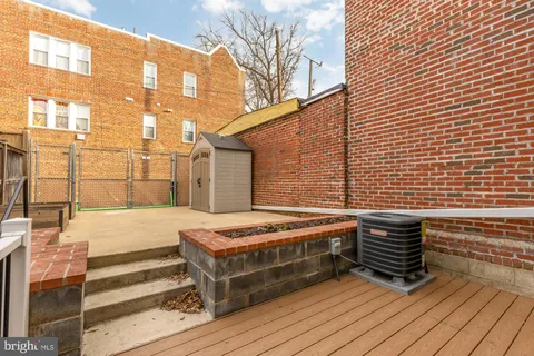 a view of a balcony with wooden floor and fence
