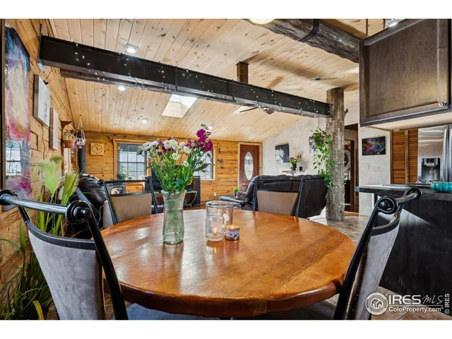 a view of a dining room with furniture and a chandelier