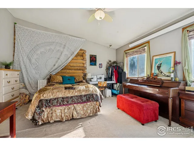 a bedroom with a bed mirror and window