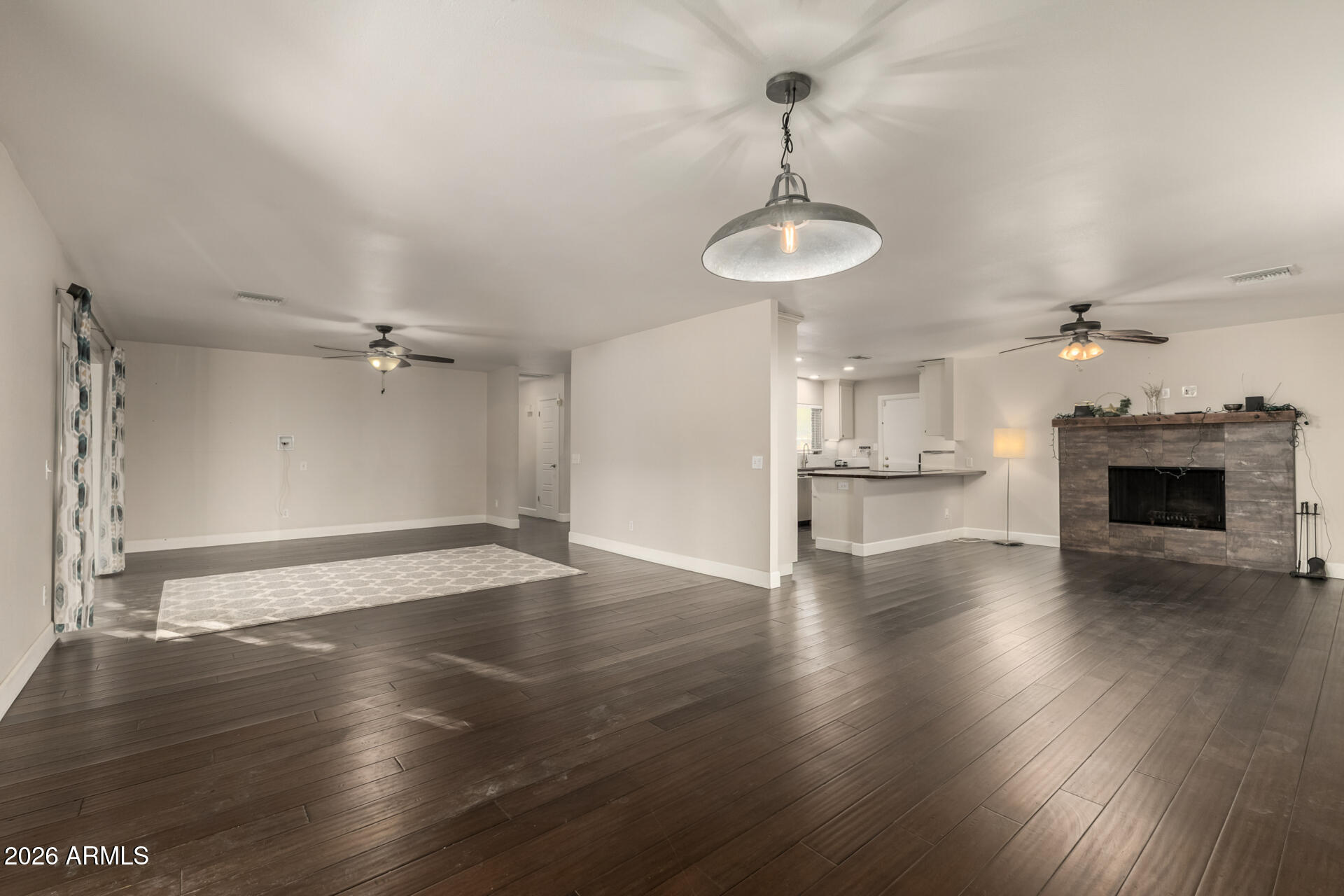 1649 West Royal Palm Road Phoenix, AZ 85021 - Photo 11 of 32 an empty room with wooden floor fireplace and window