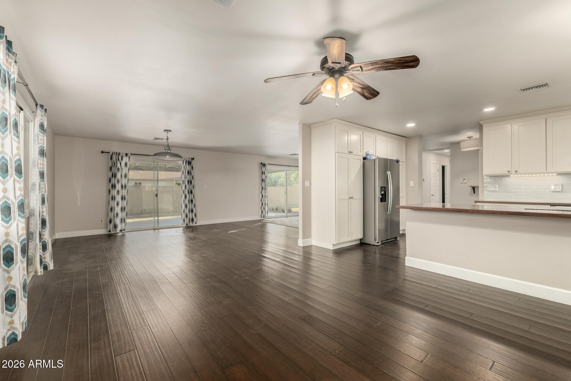 1649 West Royal Palm Road Phoenix, AZ 85021 - Photo 12 of 32 a view of a livingroom with wooden floor and a ceiling fan