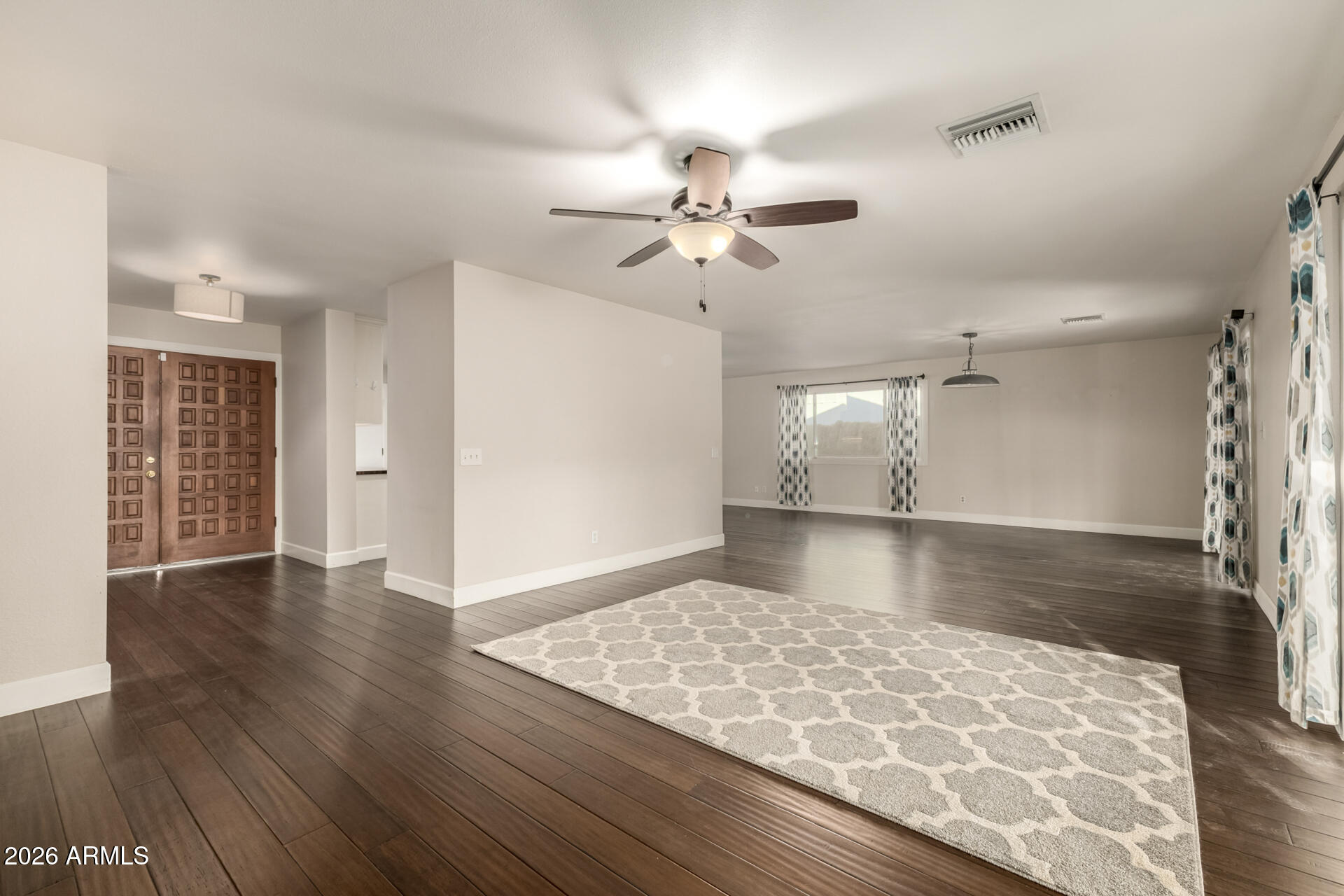 1649 West Royal Palm Road Phoenix, AZ 85021 - Photo 14 of 32 a view of an empty room with window and wooden floor