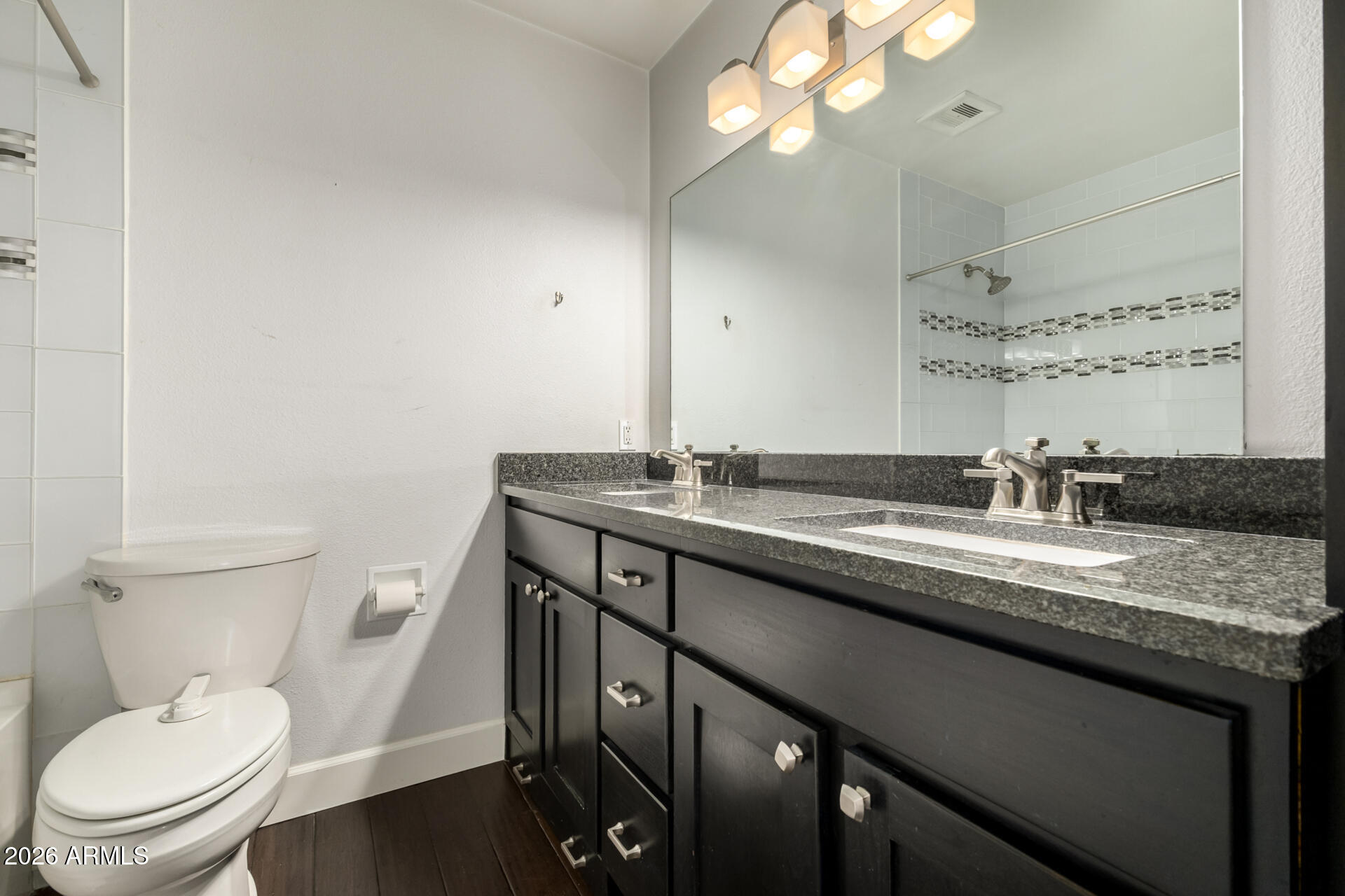 1649 West Royal Palm Road Phoenix, AZ 85021 - Photo 15 of 32 a bathroom with a granite countertop sink a toilet and a mirror