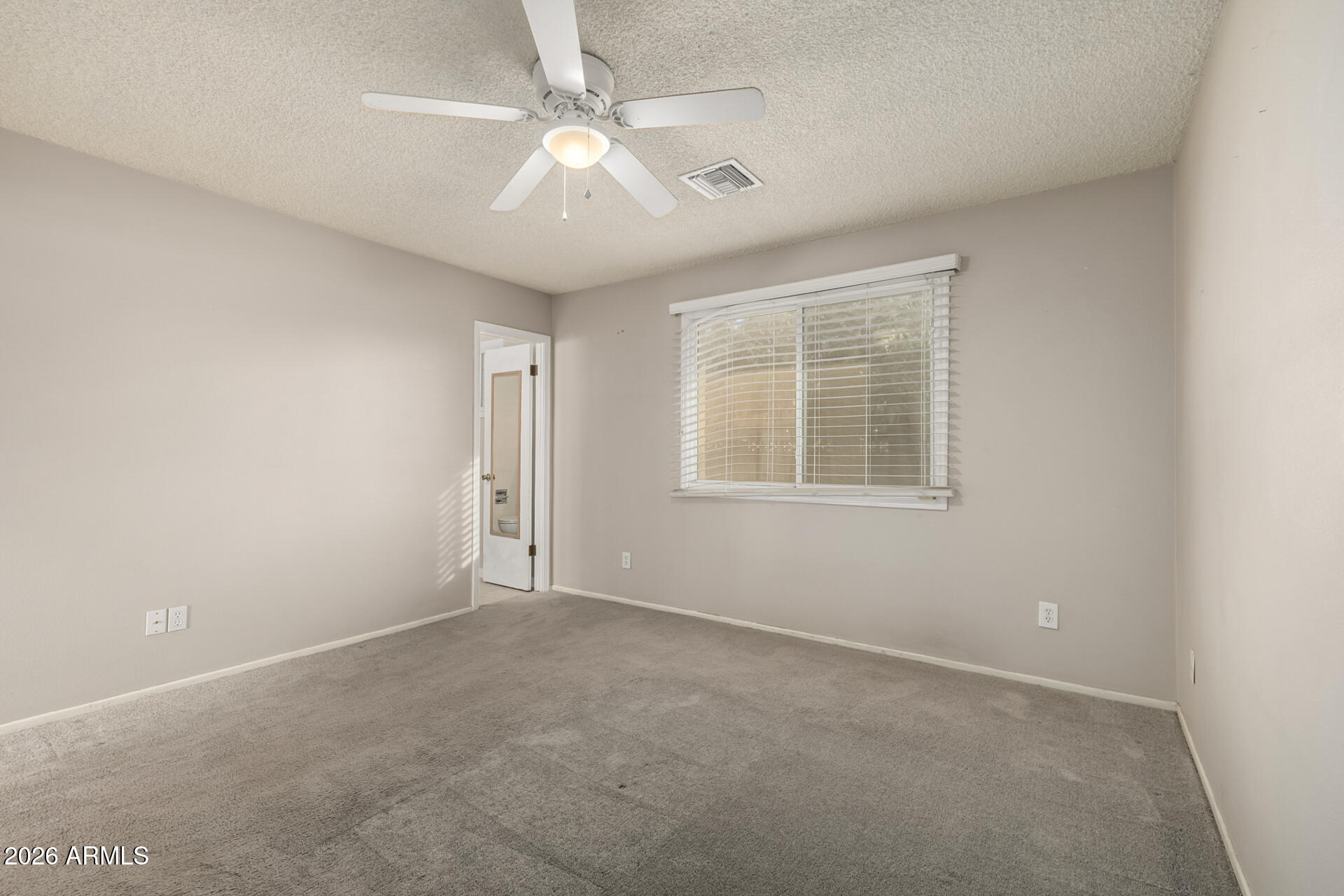 1649 West Royal Palm Road Phoenix, AZ 85021 - Photo 17 of 32 an empty room with windows and fan