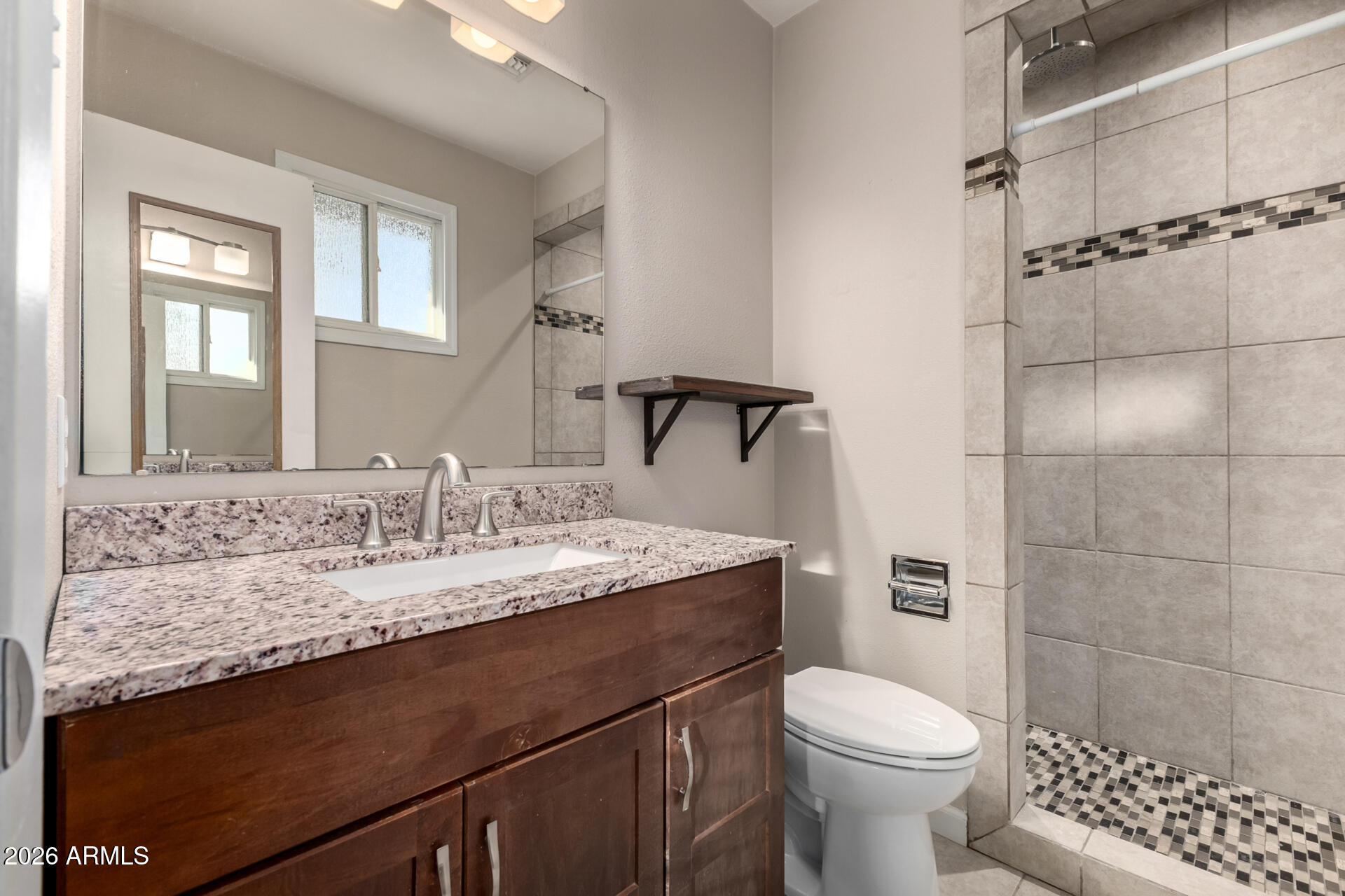 1649 West Royal Palm Road Phoenix, AZ 85021 - Photo 18 of 32 a bathroom with a granite countertop sink toilet and mirror