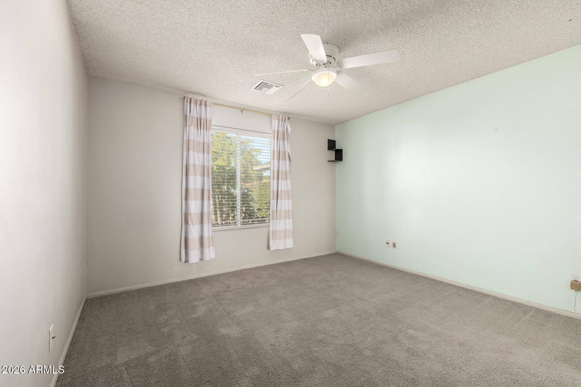 1649 West Royal Palm Road Phoenix, AZ 85021 - Photo 19 of 32 an empty room with chandelier fan