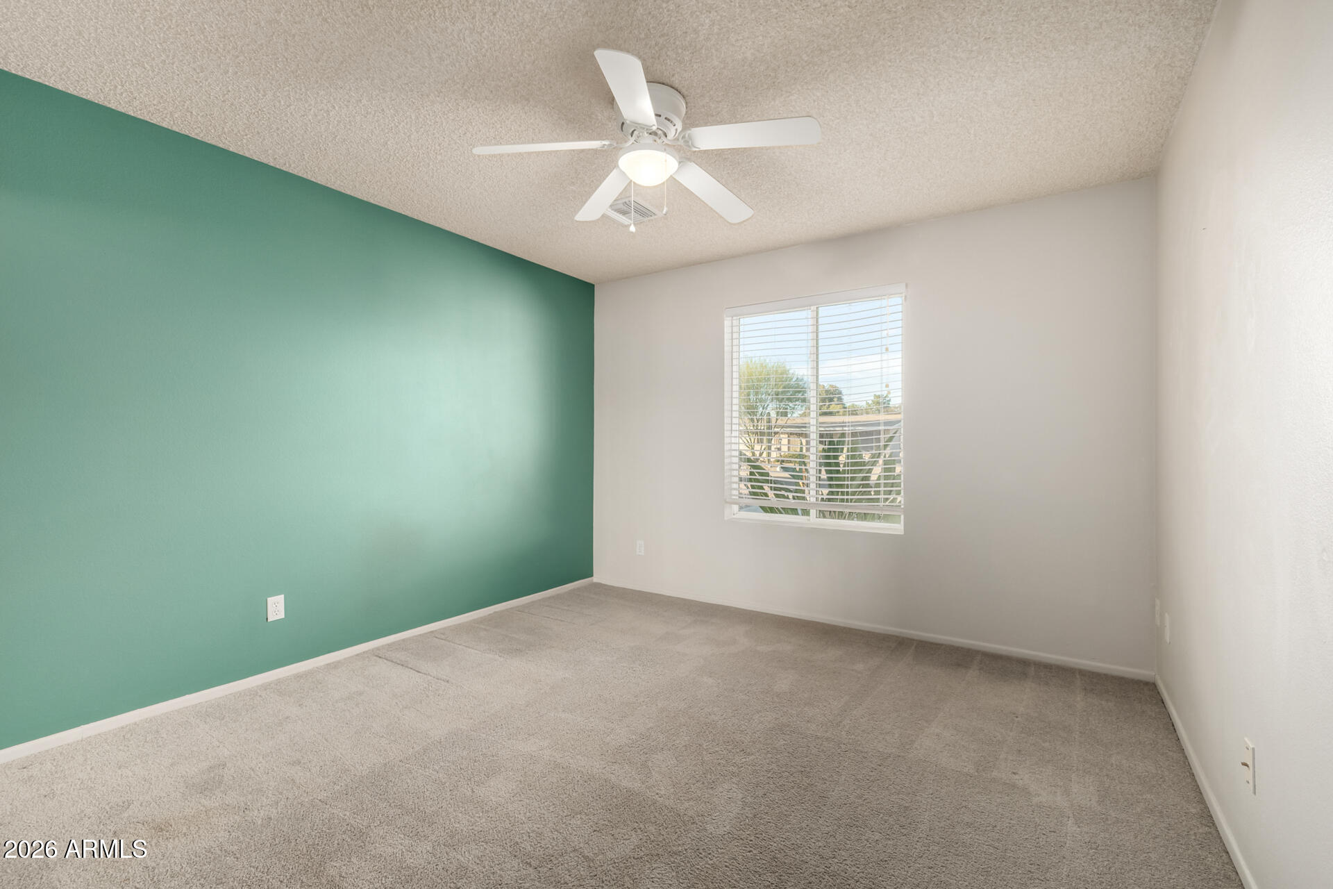1649 West Royal Palm Road Phoenix, AZ 85021 - Photo 20 of 32 an empty room with windows and ceiling fan