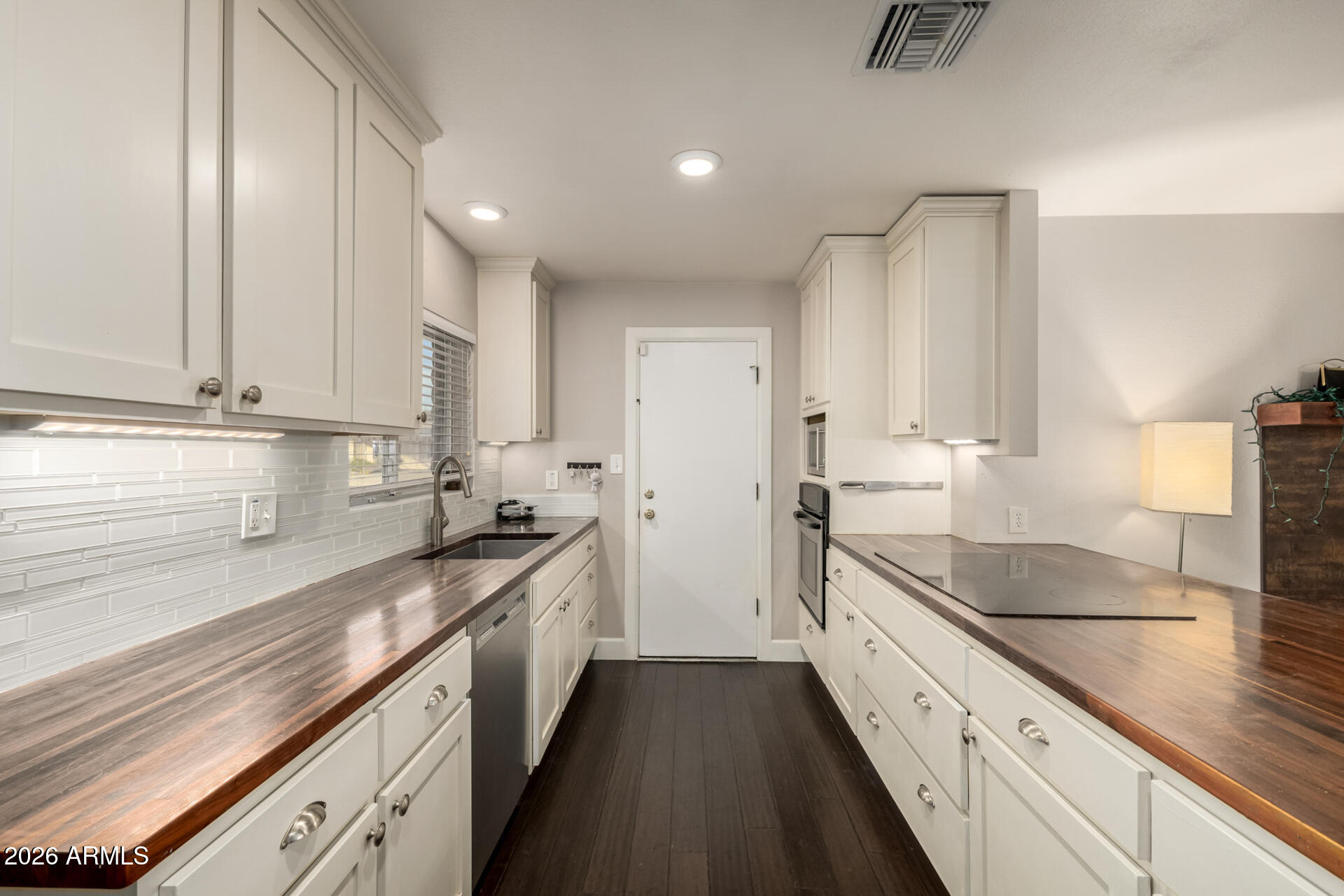 1649 West Royal Palm Road Phoenix, AZ 85021 - Photo 8 of 32 a kitchen with granite countertop sink stainless steel appliances and cabinets
