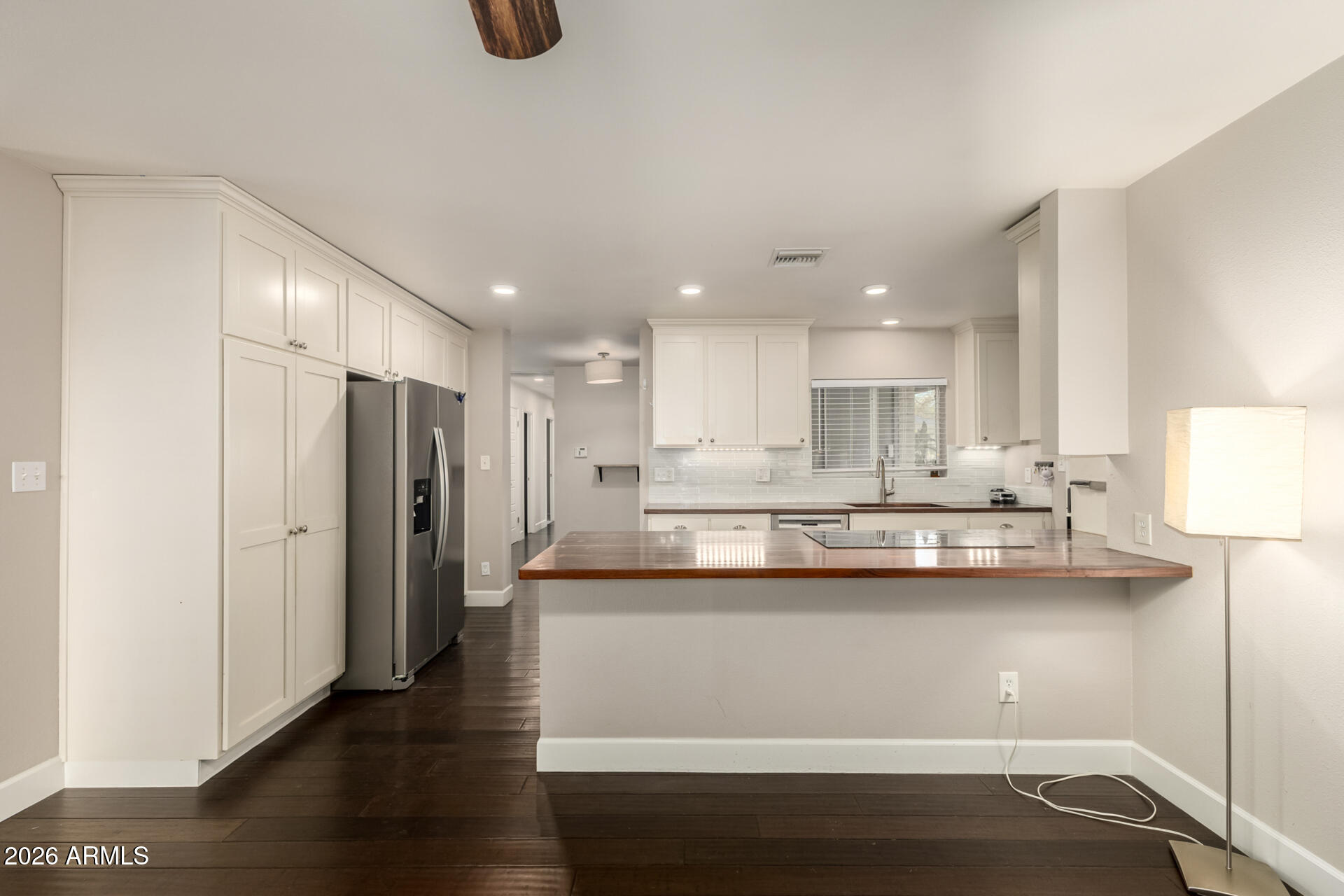 1649 West Royal Palm Road Phoenix, AZ 85021 - Photo 9 of 32 a kitchen with stainless steel appliances granite countertop a sink a stove and a refrigerator