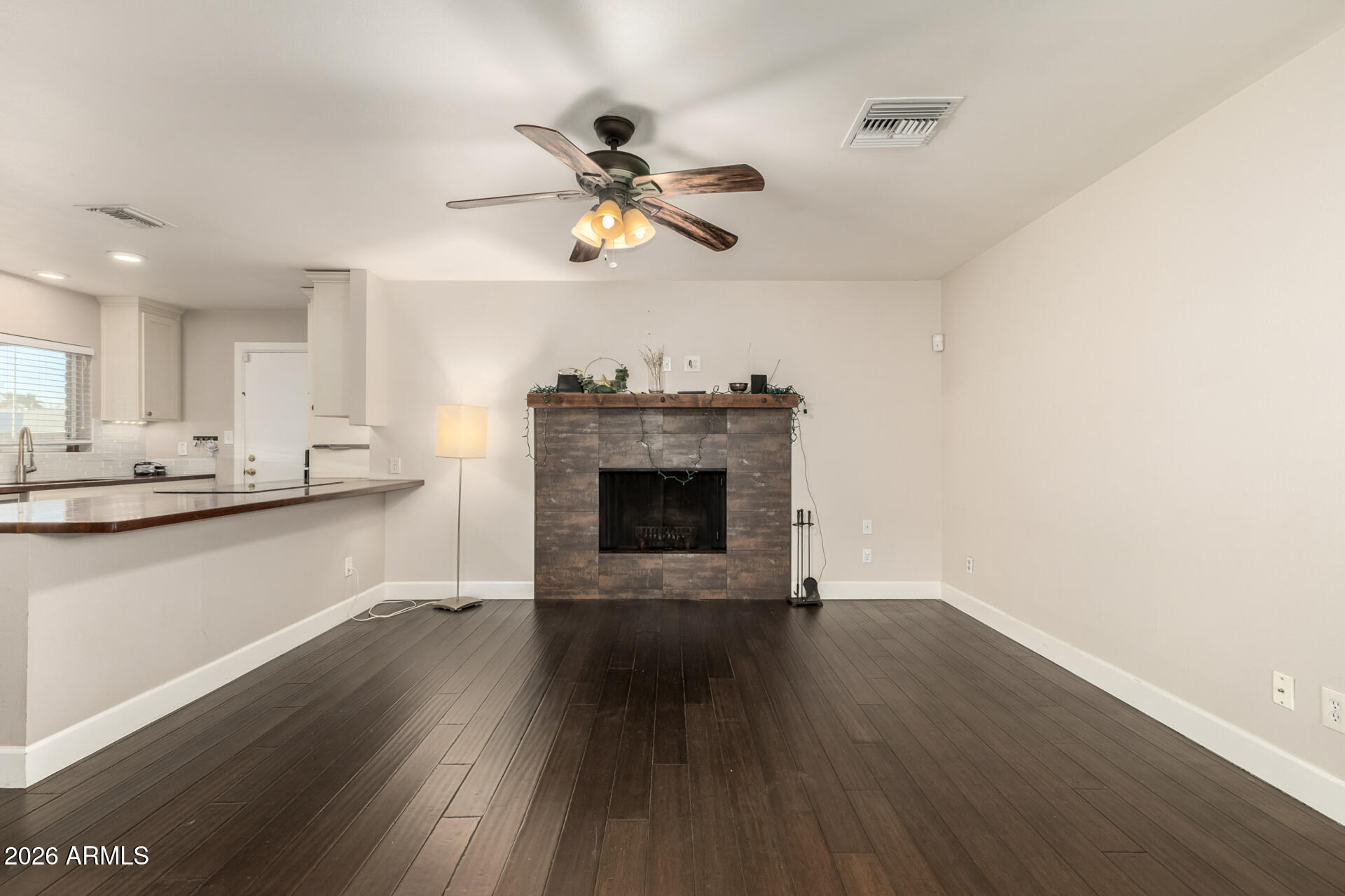 1649 West Royal Palm Road Phoenix, AZ 85021 - Photo 10 of 32 a view of an empty room with a fireplace and a window