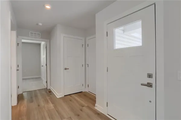 a kitchen with kitchen island granite countertop a sink stove refrigerator and cabinets