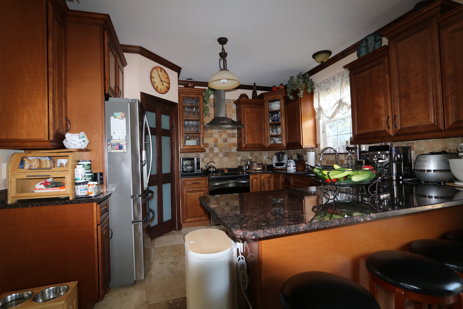 1594 Baytree Drive Romeoville, IL 60446 - Photo 3 of 32 a kitchen with stainless steel appliances granite countertop a refrigerator a stove and a sink with wooden floor