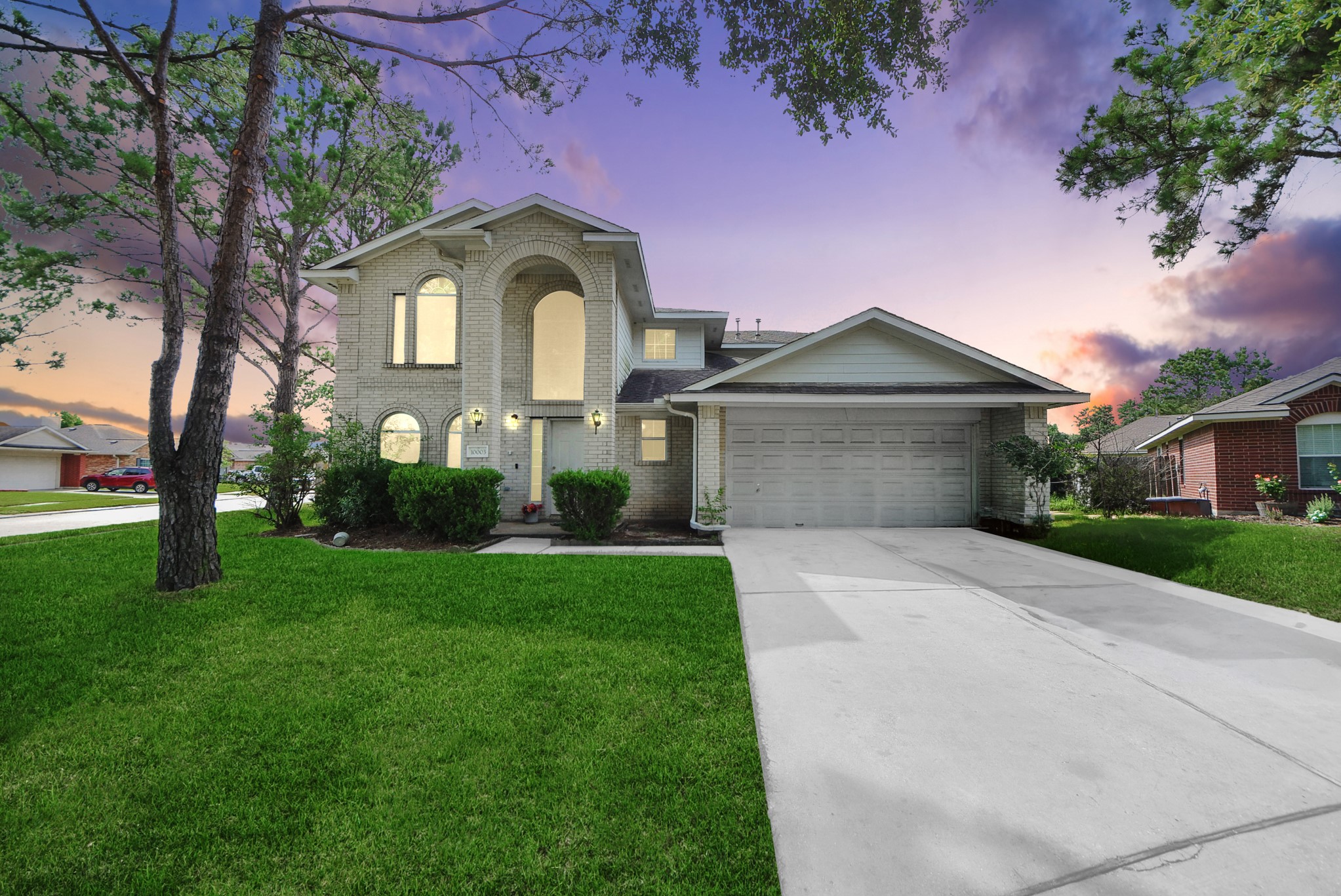 10003 Dakota Ridge Court Houston, TX 77095 - Photo 30 of 30 a front view of a house with a garden and trees
