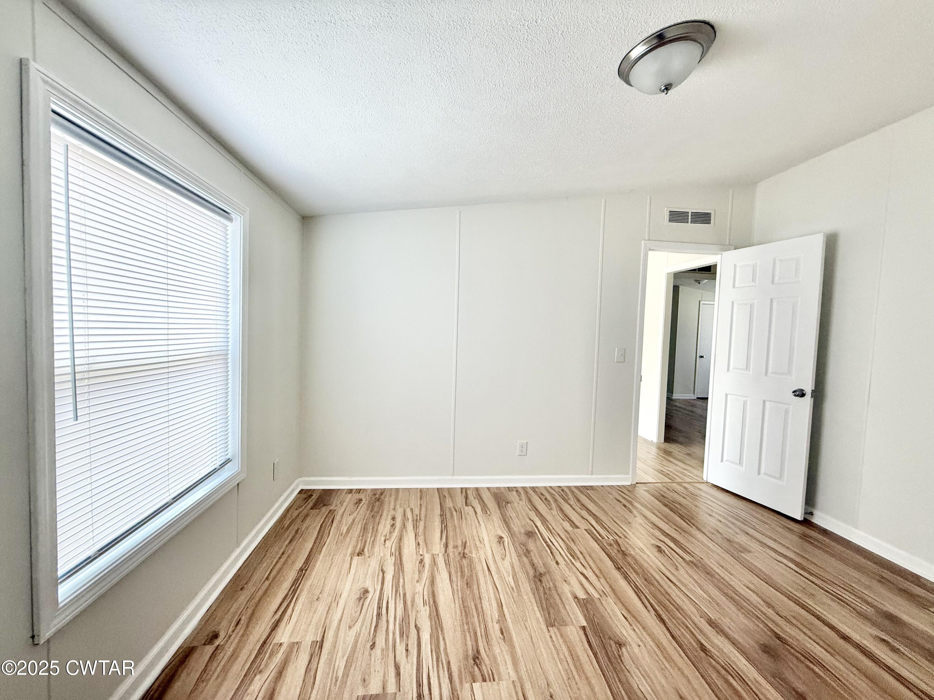 390 Emerson Road Gates, TN 38037 - Photo 45 of 54 a view of a room with wooden floor and a window
