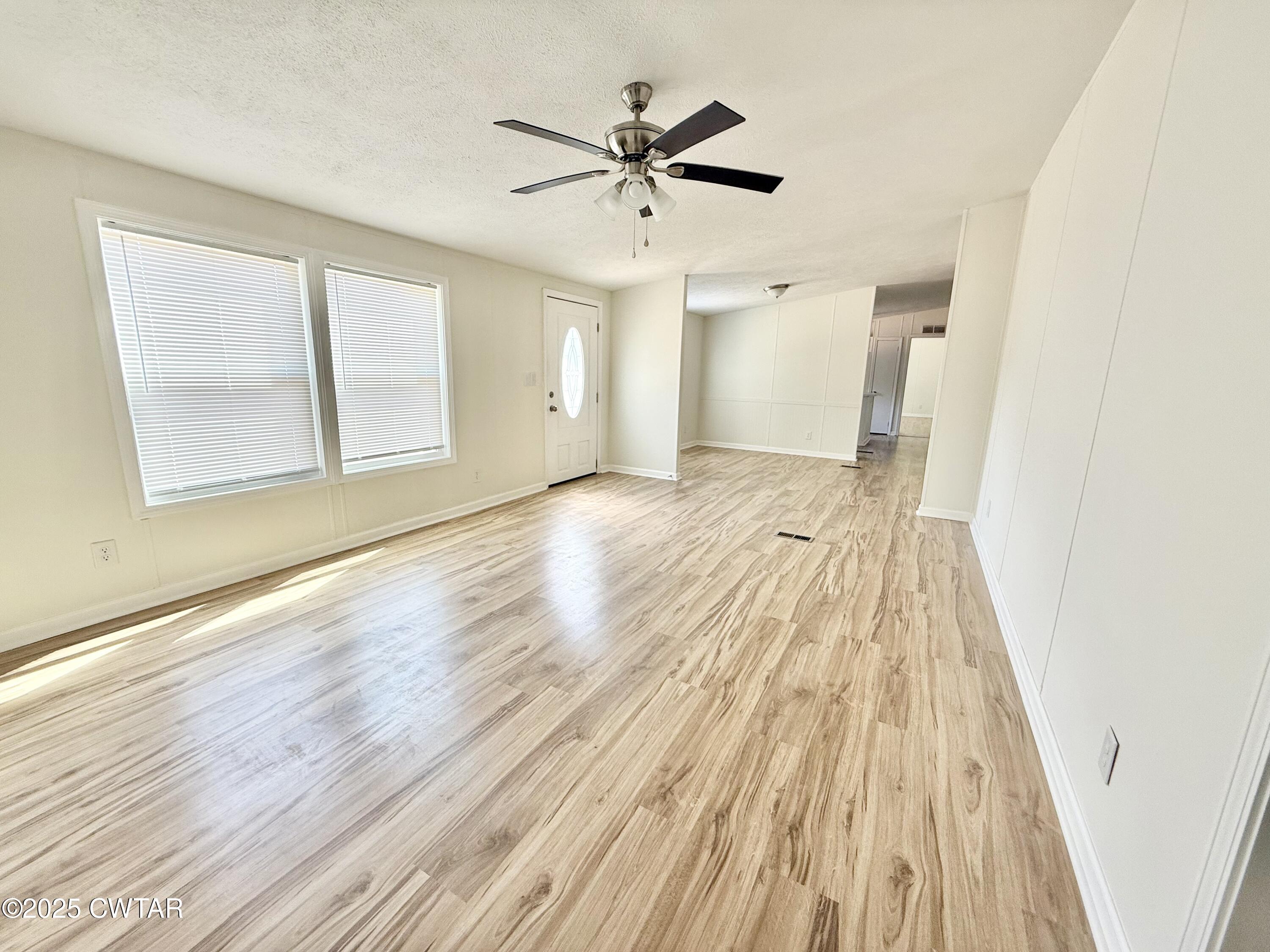 390 Emerson Road Gates, TN 38037 - Photo 5 of 54 wooden floor in an empty room with a window