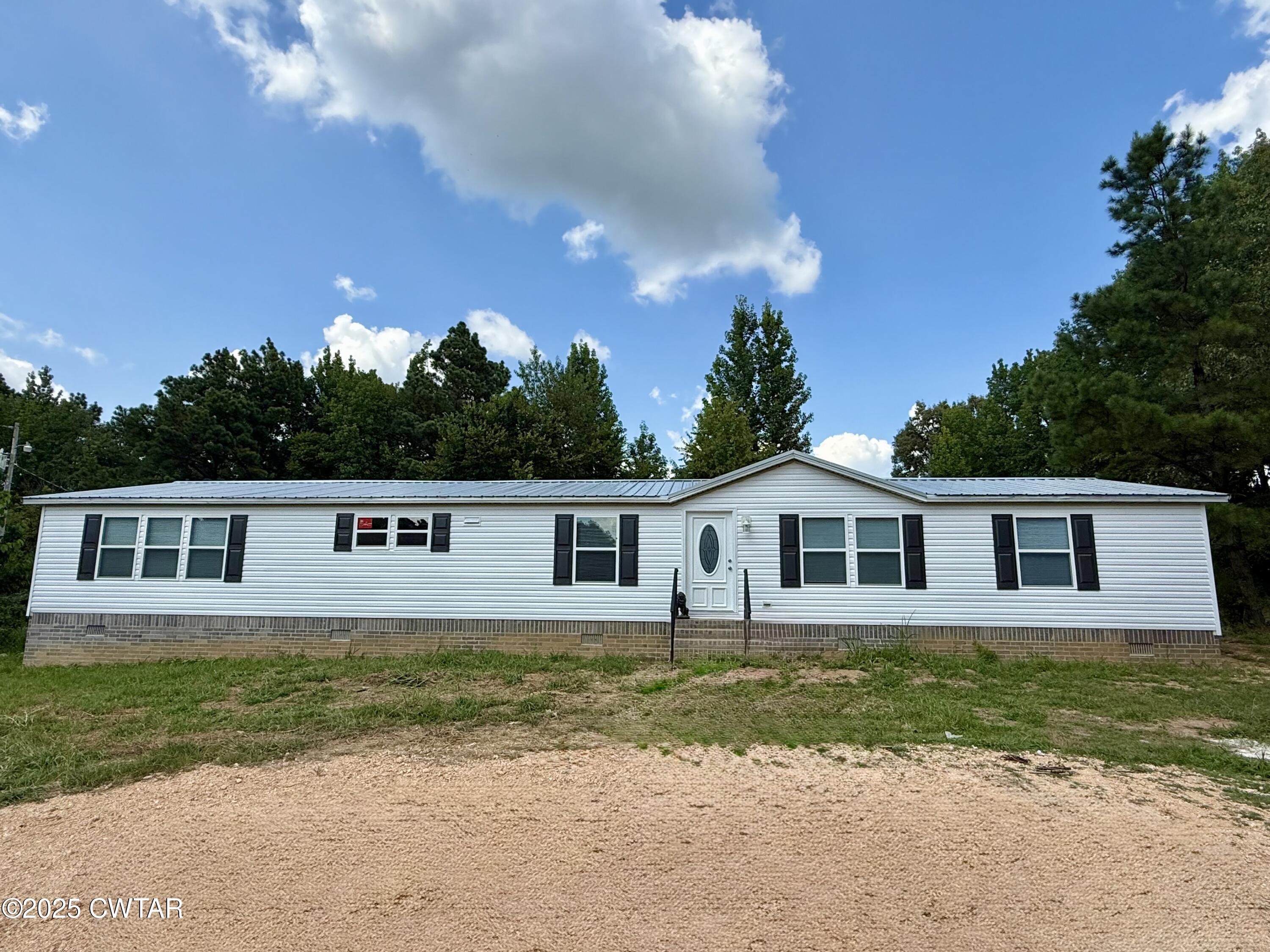 390 Emerson Road Gates, TN 38037 - Photo 54 of 54 a front view of a house with a garden and yard