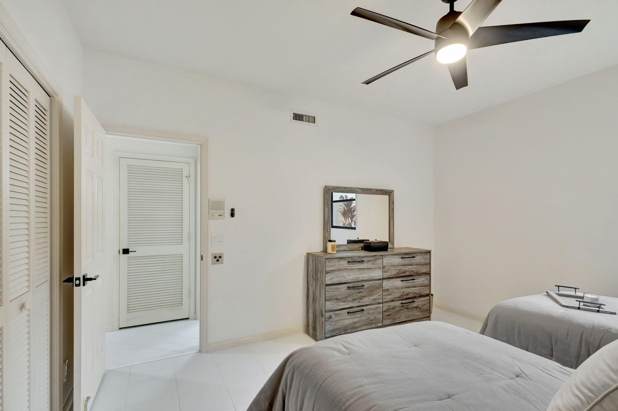 16151 West Bay Drive, Unit 161 Jupiter, FL 33477 - Photo 20 of 25 a bedroom with a bed and a ceiling fan