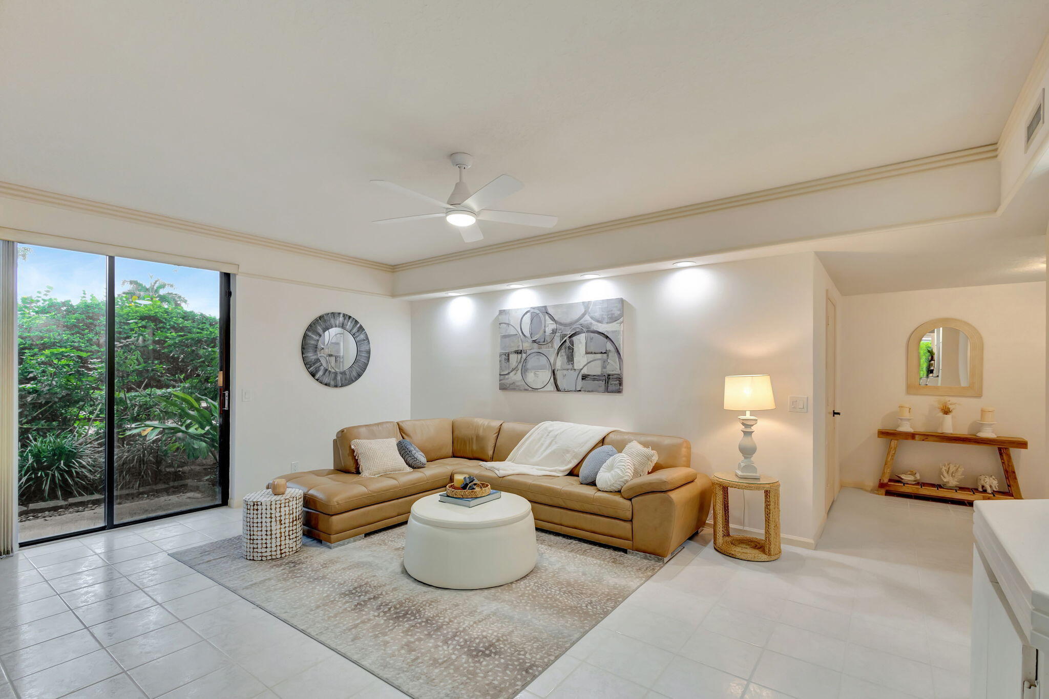 16151 West Bay Drive, Unit 161 Jupiter, FL 33477 - Photo 7 of 25 a living room with furniture a table and a large window