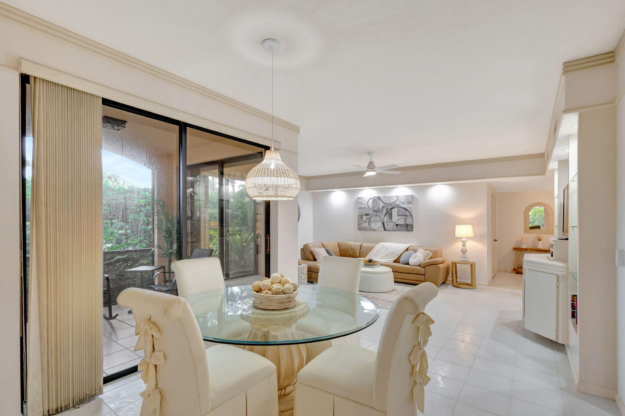 16151 West Bay Drive, Unit 161 Jupiter, FL 33477 - Photo 9 of 25 a dining room with a glass table and chairs