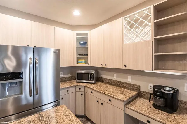 a kitchen with stainless steel appliances granite countertop a sink stove and cabinets