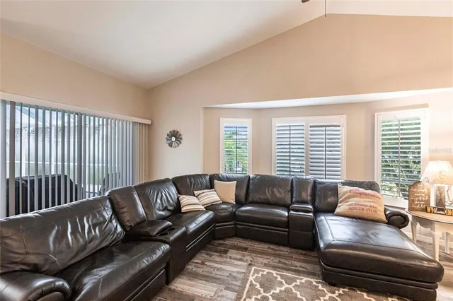 a view of a dining room with furniture water view and a floor to ceiling window
